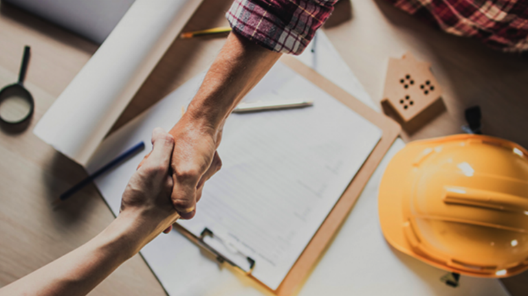 Shaking hands over paperwork