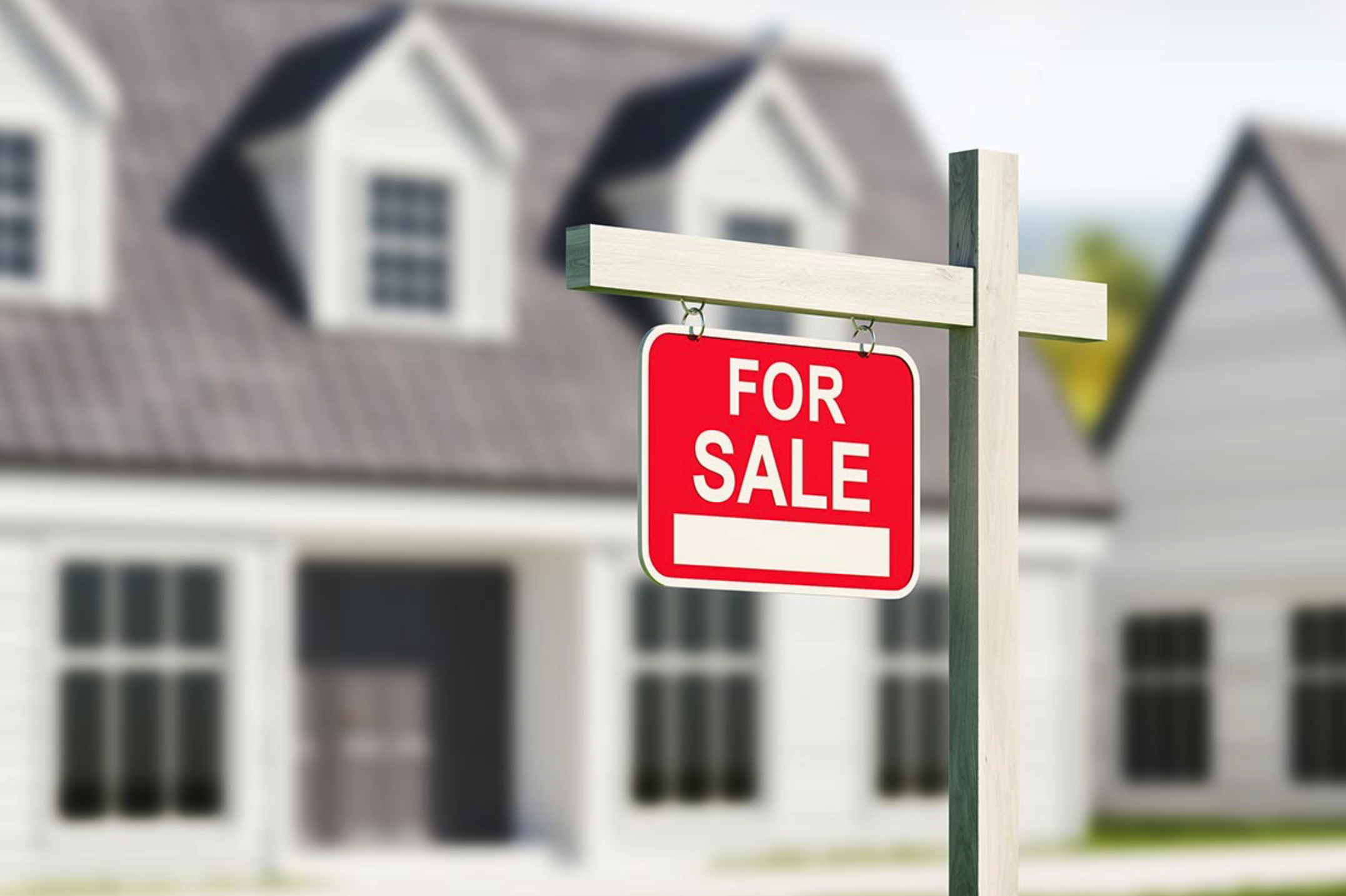 For Sale sign posted outside a home.