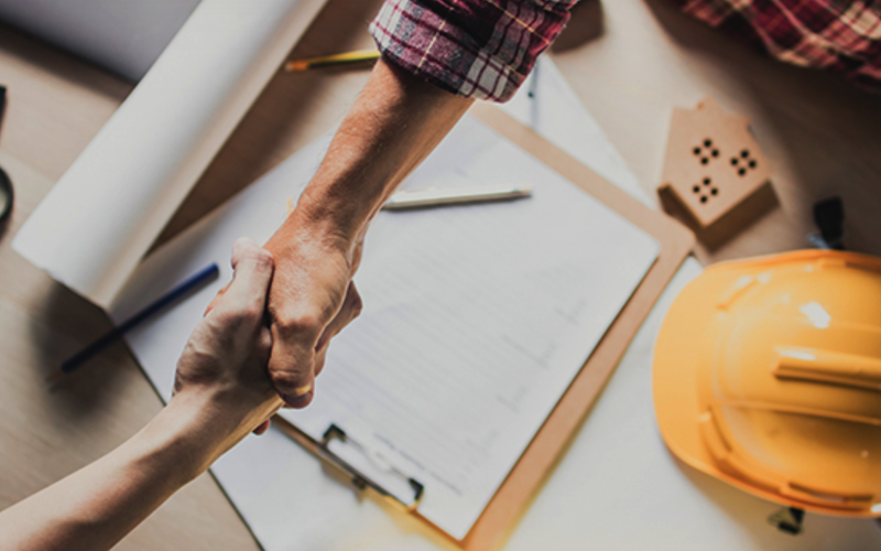 Shaking hands over paperwork